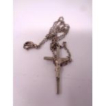 A silver crucifix on chain.