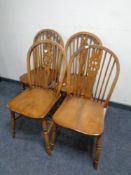 A set of four wheel backed chairs