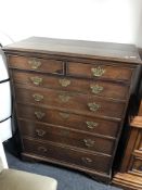A George III oak seven drawer chest with brass drop handles