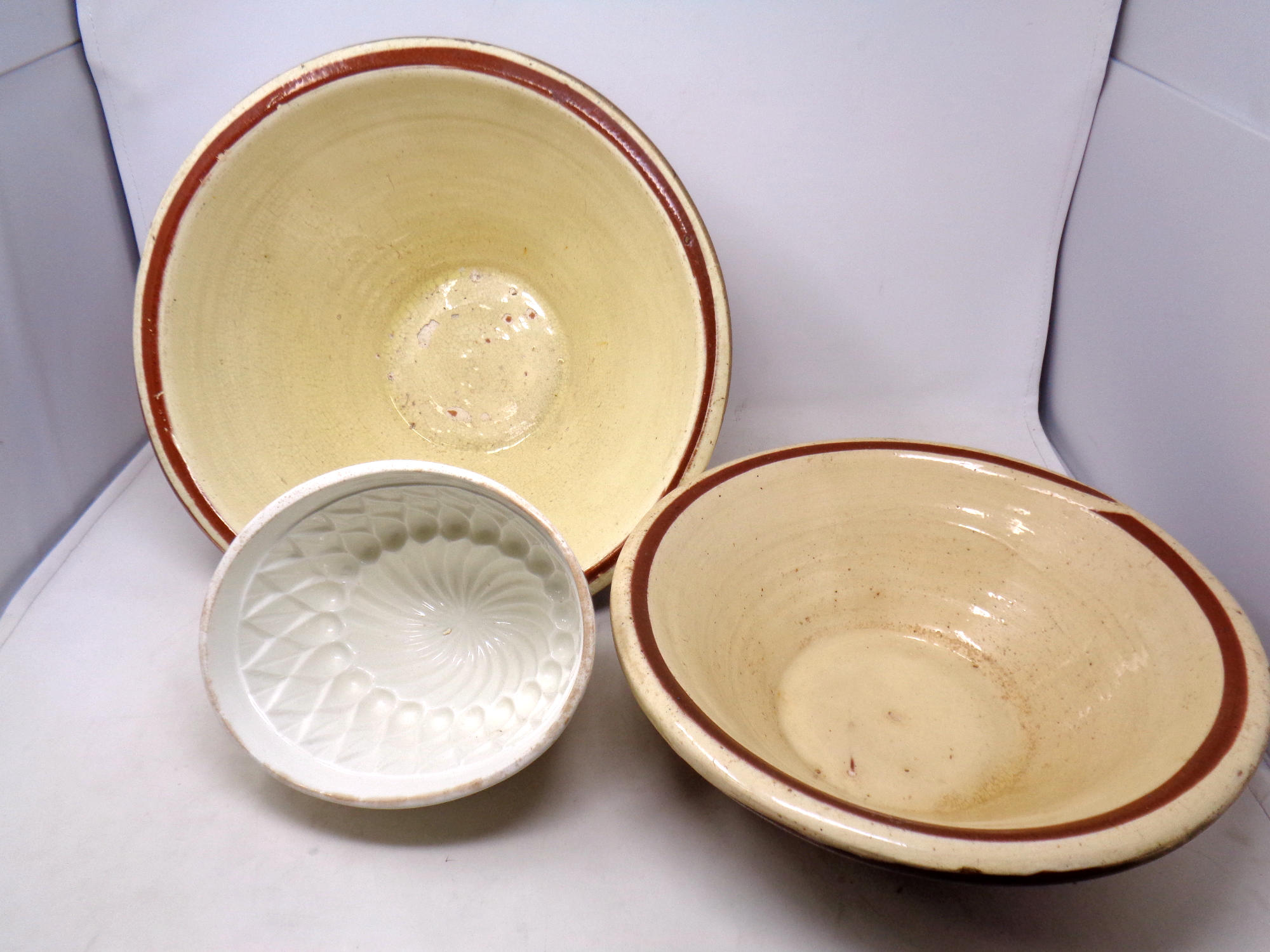 Two glazed crock pots together with a glazed pie dish