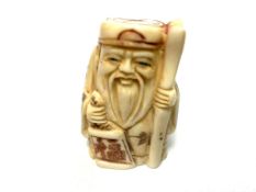 A Japanese bone carving - Village Elder with Scroll.