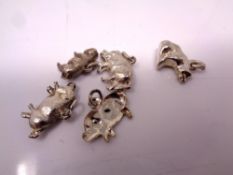 Five silver pig charms.