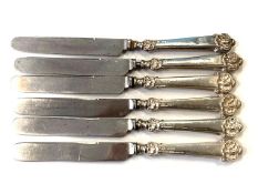 Six cake knives with Silver handles.