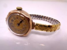 A 9ct Gold Swiss lady's wrist watch on expansion strap.
