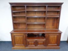 A set of Victorian mahogany open bookshelves fitted with cupboards