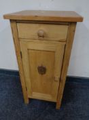 A stripped pine pot cupboard fitted a drawer