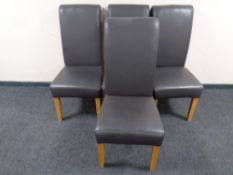 A set of four contemporary high backed leather dining chairs