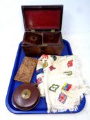 A tray of silk embroidered cloth, leather stitched tape measure, 19th century tea caddy,