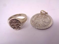 A heavy silver ring. Together with a double sided St Christopher pendant.