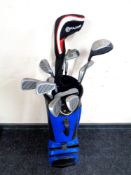 A golf bag containing irons and drivers