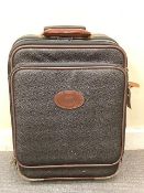 A Mulberry Scotchgrain (black with dark tan leather trimmings) cabin-sized suitcase,