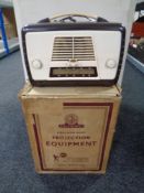 A mid century bakelite cased radio together with a Bell and Howell projector in original box