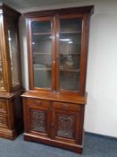 A Victorian mahogany double door bookcase fitted with drawers
