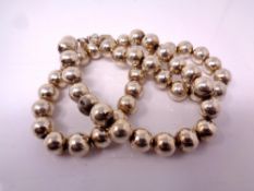 A white metal ball necklace.