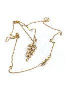 An 18ct yellow gold diamond leaf style pendant and chain