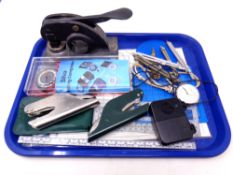 A tray of compass, metal stamp,