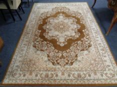 A woolen floral carpet on brown ground 201 cm x 295 cm.