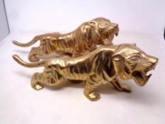 A pair of cast brass tiger ornaments