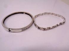 A silver bangle and bracelet.