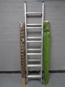 A set of aluminium folding ladders together with two wind breaks