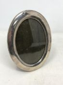 A silver oval photo frame,