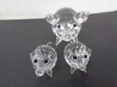 Three Swarovski pig figures