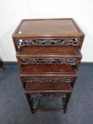 A nest of carved Chinese 20th century tables