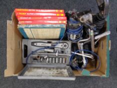 A box of Haynes car manuals, inspection lamps,