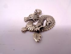 A silver dragon pendant.