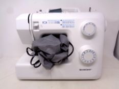 A Silver Crest electric sewing machine with pedal