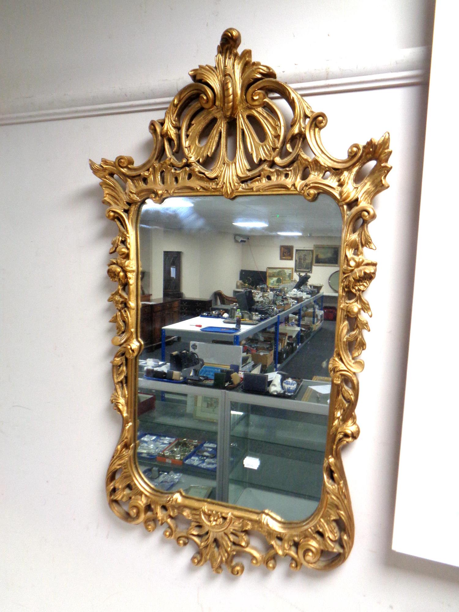 A twentieth century antique style mirror 87 cm x 49 cm.