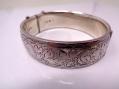 A silver engraved bangle.