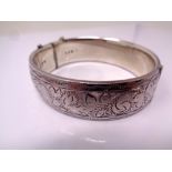 A silver engraved bangle.