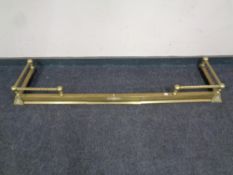 A brass extending fire curb together with brass coal scuttle