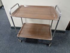 A mid century tubular chrome two tier coffee table with plastic trays