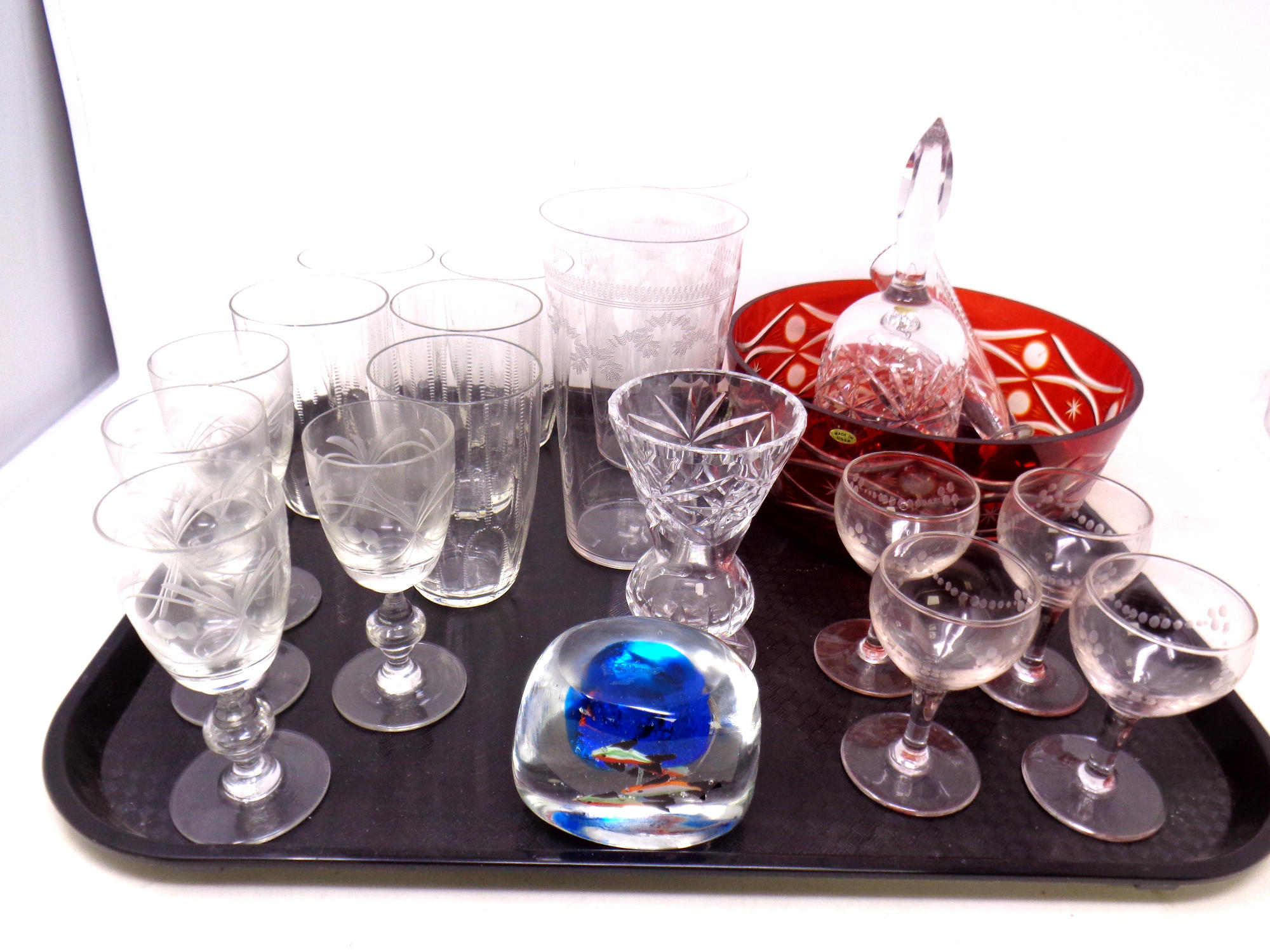 A tray containing antique and later glassware to include etched glass pint glasses, beakers,