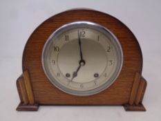 A 1930's oak cased Garrard mantel clock with key and pendulum