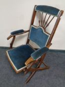 An Edwardian mahogany campaign style folding armchair