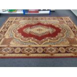 A machined Persian design carpet on gold and red ground with central medallion
