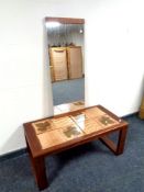 A mid 20th century teak tile topped coffee table together with a wall mirror