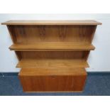 A mid 20th century Danish teak bureau cupboard together with a pair of open bookshelves