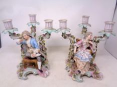 A pair of Meissen style figural three-way candelabrum (a/f)