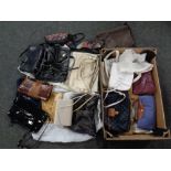 A box containing assorted lady's hand bags including leather and crocodile skin examples