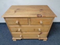 A stripped pine four drawer chest