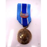 A UN medal on ribbon with enameled badge