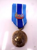 A UN medal on ribbon with enameled badge