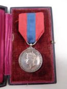 A George IV faithful service medal on ribbon in case.