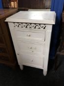 A contemporary French style three drawer bedside chest