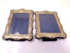 A pair of silver photo frames.
