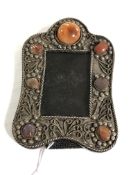 An ornate miniature white metal picture frame with polished stone decoration, height 12 cm,